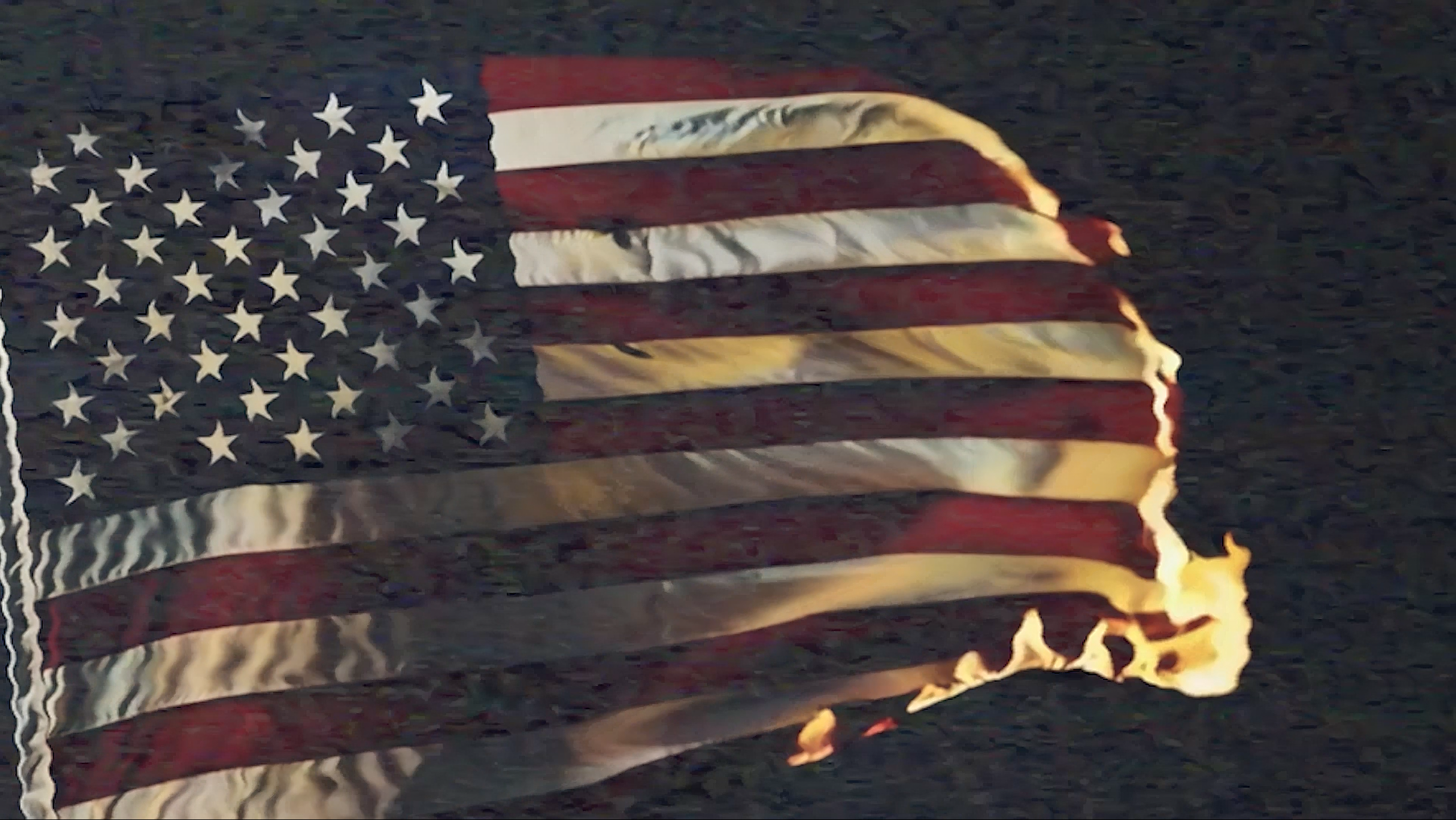 Image of an American flag burning, with flames consuming the fabric against a dark background.